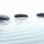Image of stones in water from Full Circle Health and Wellness.