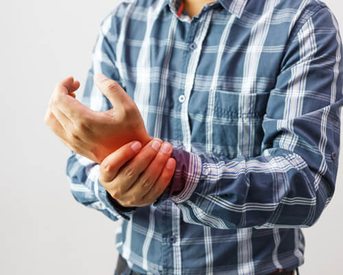Man experiencing arthritis pain in  his hands.